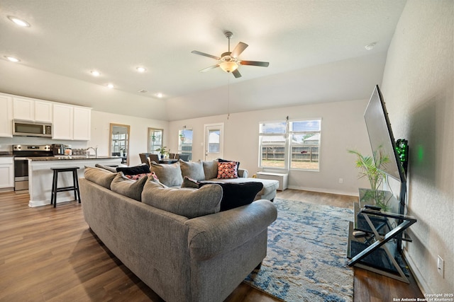 6907 Emerald Vly, San Antonio, TX 78242 - living room featuring a ceiling fan, wood finished floors, recessed lighting, baseboards, and vaulted ceiling