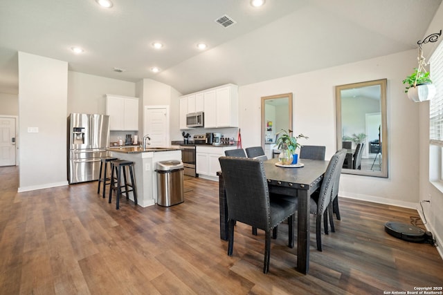 6907 Emerald Vly, San Antonio, TX 78242 - dining room featuring vaulted ceiling, dark wood-type flooring, baseboards, and recessed lighting