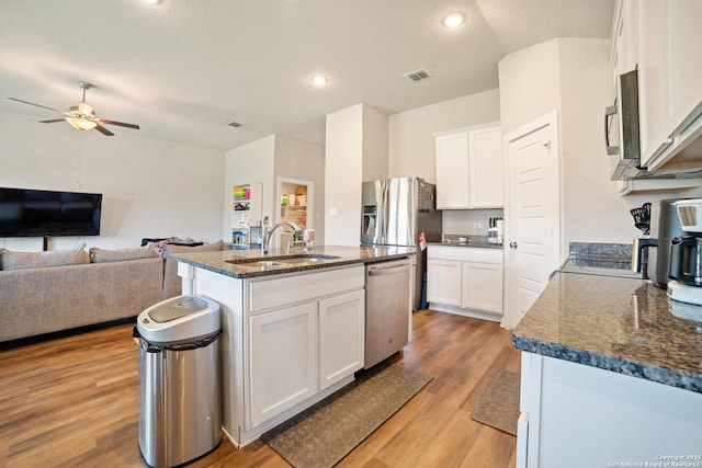 6907 Emerald Vly, San Antonio, TX 78242 - kitchen featuring stainless steel appliances, a sink, light wood finished floors, ceiling fan, and white cabinets