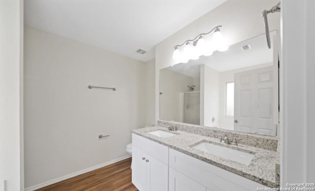 4039 Privet, San Antonio, TX 78259 - full bath featuring a stall shower, double vanity, toilet, wood finished floors, and baseboards