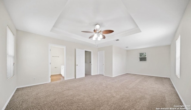 4039 Privet, San Antonio, TX 78259 - unfurnished bedroom featuring light colored carpet, a raised ceiling, baseboards, and connected bathroom