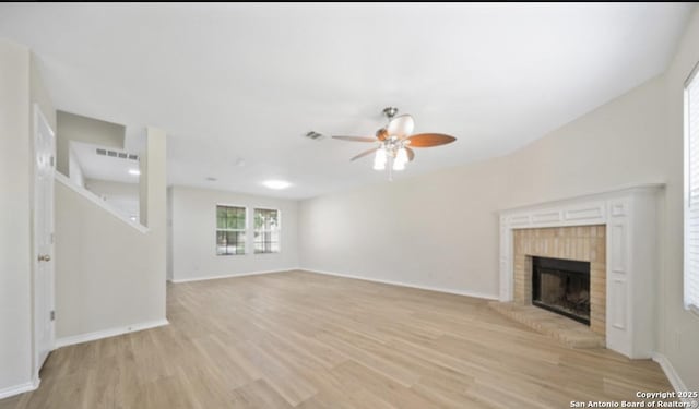 4039 Privet, San Antonio, TX 78259 - unfurnished living room featuring light wood-style flooring, a ceiling fan, a fireplace, and baseboards