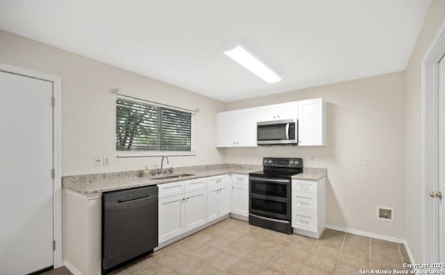 4039 Privet, San Antonio, TX 78259 - kitchen with range with two ovens, dishwashing machine, stainless steel microwave, a sink, and white cabinets