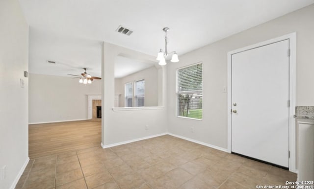 4039 Privet, San Antonio, TX 78259 - foyer entrance featuring a fireplace, ceiling fan, a chandelier, and baseboards