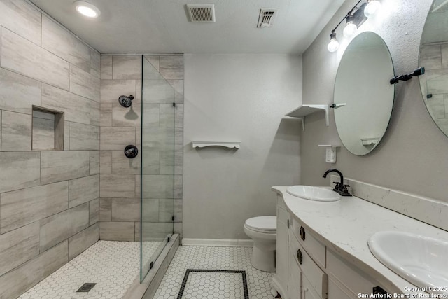 289 Deer Slayer, Seguin, TX 78155 - bathroom with tile patterned floors, tiled shower, double vanity, toilet, and baseboards