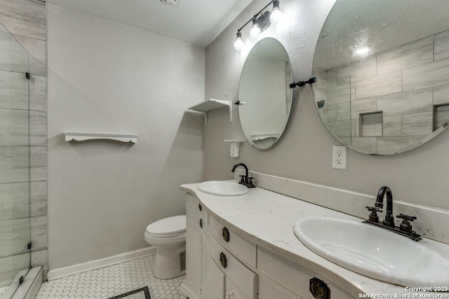 289 Deer Slayer, Seguin, TX 78155 - bathroom with a baseboard radiator, tile patterned floors, toilet, double vanity, and tiled shower