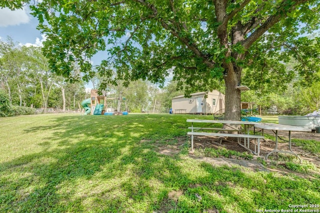 289 Deer Slayer, Seguin, TX 78155 - view of grassy yard featuring a playground and view of scattered trees