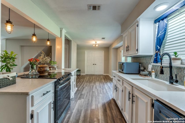 289 Deer Slayer, Seguin, TX 78155 - kitchen with electric range oven, a sink, dishwasher, white cabinetry, and wood finished floors