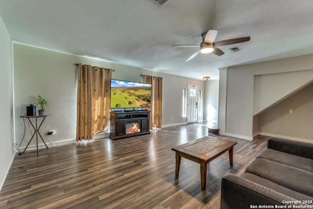 289 Deer Slayer, Seguin, TX 78155 - living area featuring wood finished floors, a ceiling fan, baseboards, and a glass covered fireplace