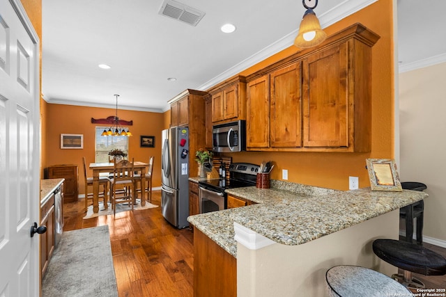1355 Lasso, Canyon Lake, TX 78133 - kitchen featuring stainless steel appliances, brown cabinets, crown molding, dark wood-style flooring, and baseboards