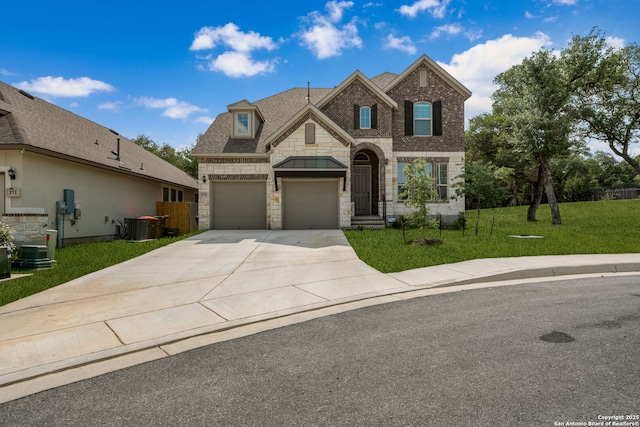 375 Sonata Cyn, Spring Branch, TX 78070 - view of front facade with stone siding, concrete driveway, a front yard, central AC, and brick siding