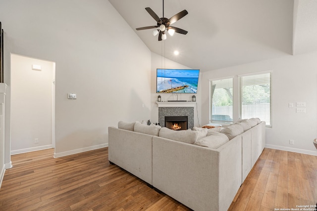 375 Sonata Cyn, Spring Branch, TX 78070 - living room with a ceiling fan, high vaulted ceiling, light wood-style flooring, a fireplace, and baseboards