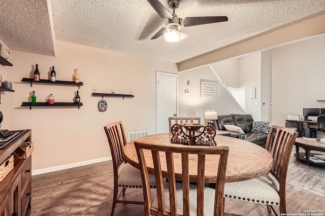 8517 Echo Crk, San Antonio, TX 78240 - dining space featuring ceiling fan, dark wood-style flooring, a textured ceiling, and baseboards