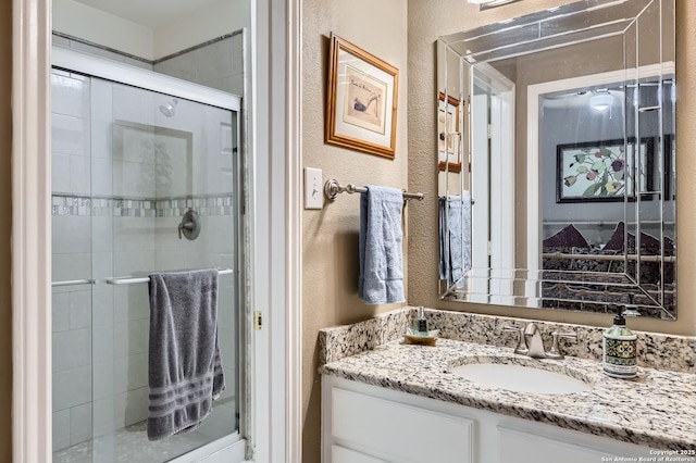 1730 Escada, San Antonio, TX 78258 - bathroom featuring vanity, a stall shower, and a textured wall