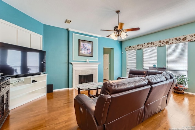 1730 Escada, San Antonio, TX 78258 - living room with a ceiling fan, light wood finished floors, a fireplace, and baseboards