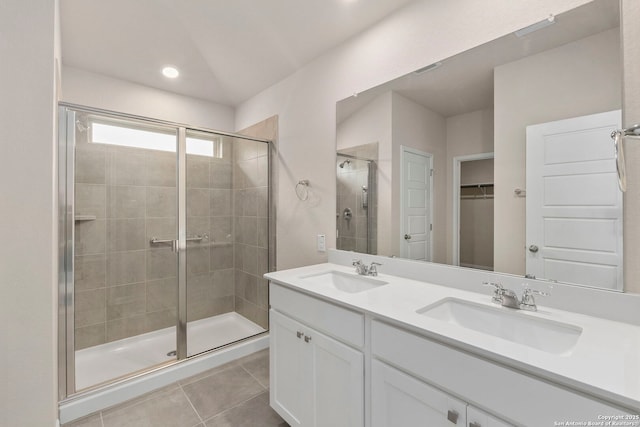 3065 Charyn Way, New Braunfels, TX 78132 - bathroom featuring a stall shower, double vanity, tile patterned floors, and a walk in closet
