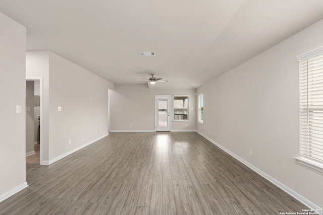 3065 Charyn Way, New Braunfels, TX 78132 - unfurnished living room with a ceiling fan, wood finished floors, and baseboards