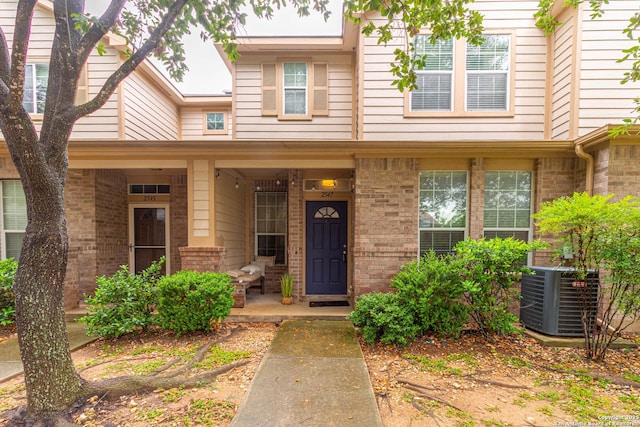 2547 Grayson, San Antonio, TX 78232 - view of front facade featuring central AC unit, a porch, and brick siding