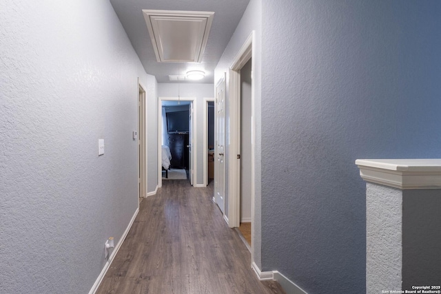 2547 Grayson, San Antonio, TX 78232 - hallway featuring attic access, wood finished floors, a textured wall, and baseboards