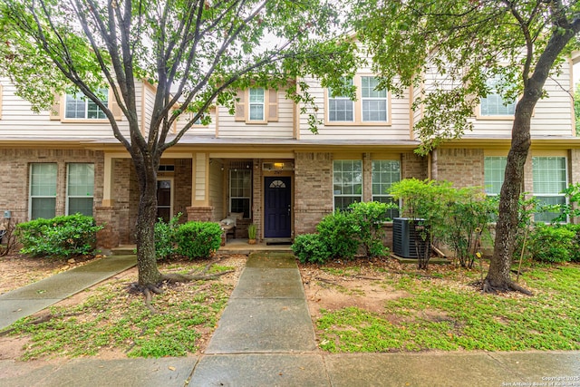 2547 Grayson, San Antonio, TX 78232 - view of property featuring central AC, covered porch, and brick siding