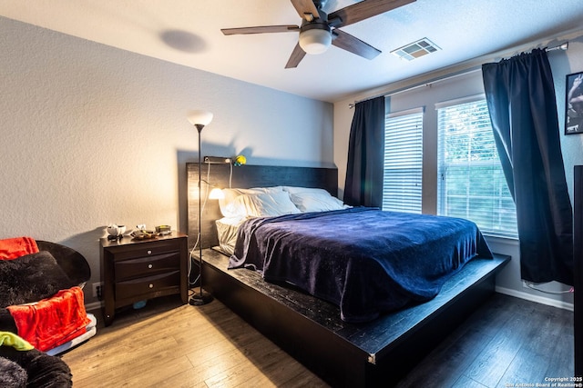 2547 Grayson, San Antonio, TX 78232 - bedroom with hardwood / wood-style flooring, a textured wall, and ceiling fan