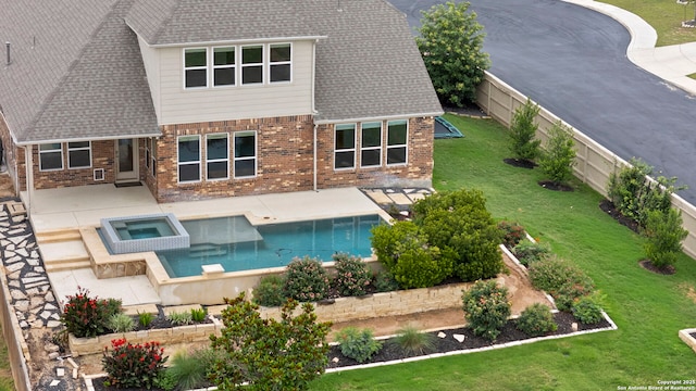 3082 Bright Skies, San Antonio, TX 78261 - back of house featuring a patio, roof with shingles, brick siding, and a pool with connected hot tub