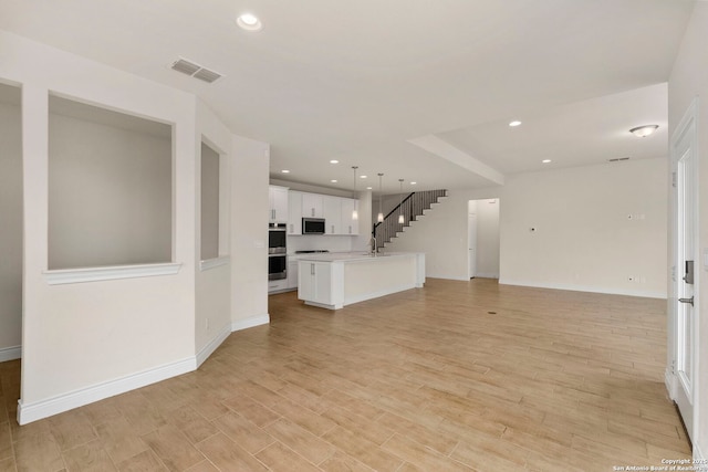3082 Bright Skies, San Antonio, TX 78261 - unfurnished living room featuring baseboards, light wood finished floors, and recessed lighting