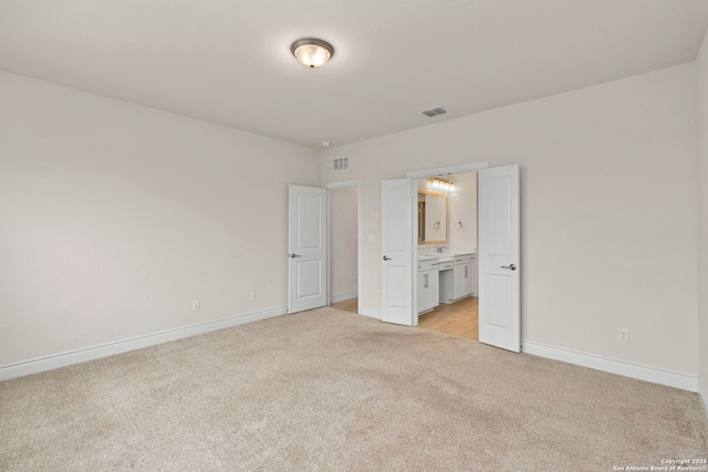3082 Bright Skies, San Antonio, TX 78261 - unfurnished bedroom with light carpet, baseboards, and ensuite bathroom