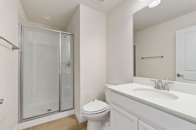 3082 Bright Skies, San Antonio, TX 78261 - full bathroom with a stall shower, toilet, vanity, and wood tiled floors