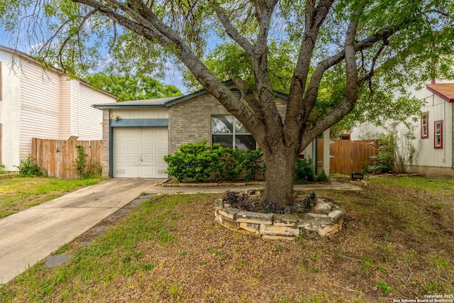 2435 Westgard, San Antonio, TX 78245 - view of front of home featuring an attached garage, driveway, and brick siding