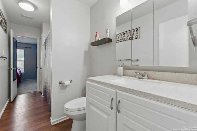 2435 Westgard, San Antonio, TX 78245 - bathroom featuring vanity, wood finished floors, toilet, and baseboards