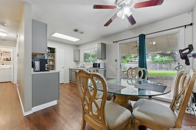 2435 Westgard, San Antonio, TX 78245 - dining space featuring washer / clothes dryer, wood finished floors, ceiling fan, and baseboards