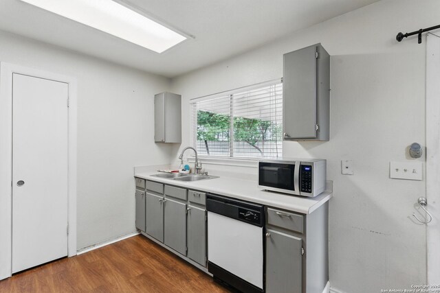 2435 Westgard, San Antonio, TX 78245 - kitchen with white dishwasher, gray cabinets, stainless steel microwave, and a sink