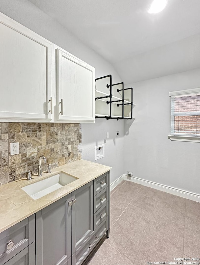 2826 Running Fawn, San Antonio, TX 78261 - washroom featuring cabinet space, electric dryer hookup, hookup for a washing machine, baseboards, and light tile patterned floors