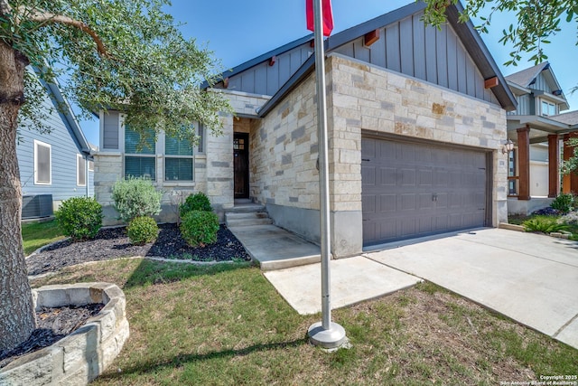 11741 Troubadour Trl, San Antonio, TX 78245 - view of front facade featuring board and batten siding, a garage, and stone siding