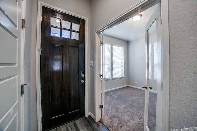 11741 Troubadour Trl, San Antonio, TX 78245 - foyer entrance with baseboards, a textured wall, and dark wood finished floors
