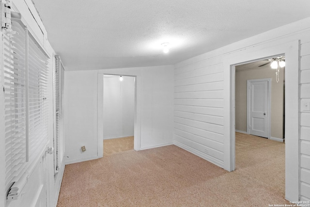 1001 Mason, San Antonio, TX 78208 - unfurnished bedroom featuring light carpet, a textured ceiling, and a spacious closet