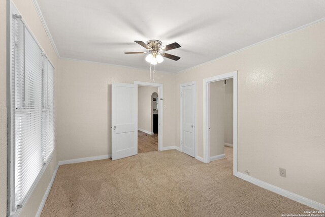 1001 Mason, San Antonio, TX 78208 - unfurnished bedroom featuring carpet floors, crown molding, a ceiling fan, and baseboards