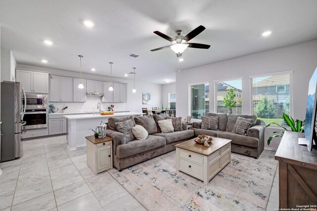 14468 Gecko Lndg, San Antonio, TX 78253 - living room with recessed lighting, ceiling fan, and light marble finish floors