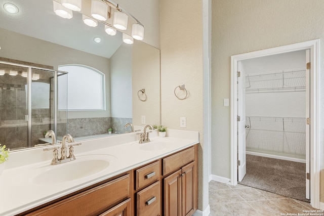 1210 Magellan, Windcrest, TX 78239 - full bathroom featuring double vanity, a shower stall, a walk in closet, and tile patterned flooring