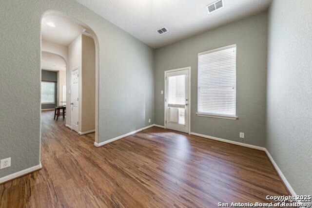 1210 Magellan, Windcrest, TX 78239 - foyer with arched walkways, wood finished floors, baseboards, and a textured wall