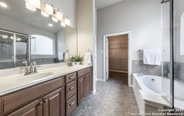 1210 Magellan, Windcrest, TX 78239 - bathroom with double vanity, a garden tub, a stall shower, a spacious closet, and tile patterned floors
