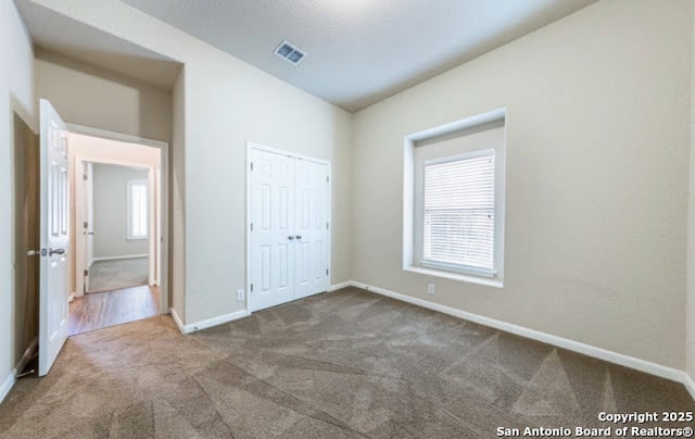 1210 Magellan, Windcrest, TX 78239 - unfurnished bedroom with carpet floors, baseboards, and a closet
