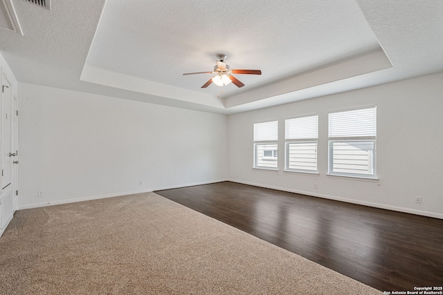 1210 Magellan, Windcrest, TX 78239 - spare room featuring a raised ceiling, a ceiling fan, dark carpet, baseboards, and a textured ceiling