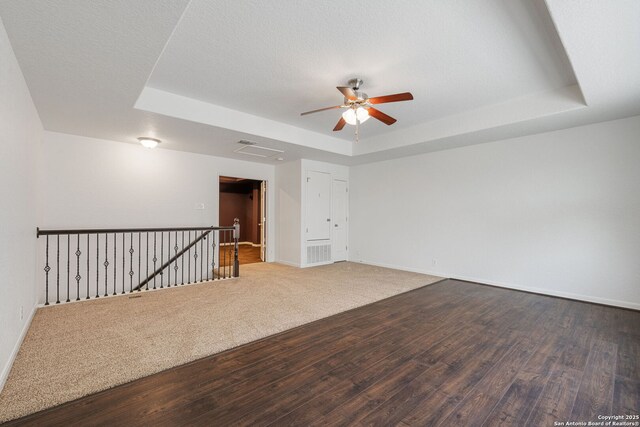 1210 Magellan, Windcrest, TX 78239 - unfurnished room featuring a tray ceiling, ceiling fan, wood finished floors, and baseboards