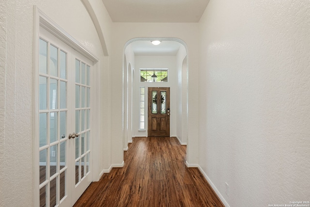 1210 Magellan, Windcrest, TX 78239 - doorway with dark wood-style floors, arched walkways, baseboards, french doors, and a textured wall