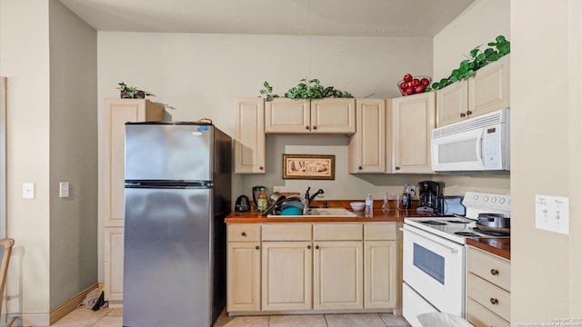 160 E Klein, New Braunfels, TX 78130 - kitchen with white appliances, a sink, light tile patterned floors, dark countertops, and cream cabinets