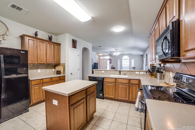 703 Point Spgs, San Antonio, TX 78253 - kitchen with black appliances, arched walkways, decorative backsplash, light tile patterned flooring, and lofted ceiling