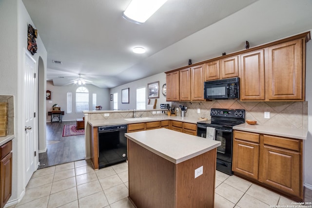 703 Point Spgs, San Antonio, TX 78253 - kitchen featuring black appliances, a peninsula, lofted ceiling, tasteful backsplash, and light countertops