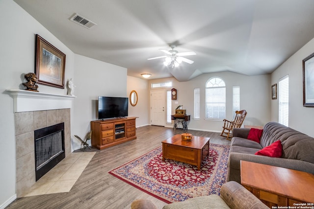 703 Point Spgs, San Antonio, TX 78253 - living room with ceiling fan, wood finished floors, lofted ceiling, a tile fireplace, and baseboards